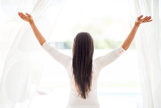 istock Happy woman at home looking through the window 469922062