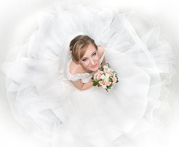 Bride in a looking-up pose stock photo