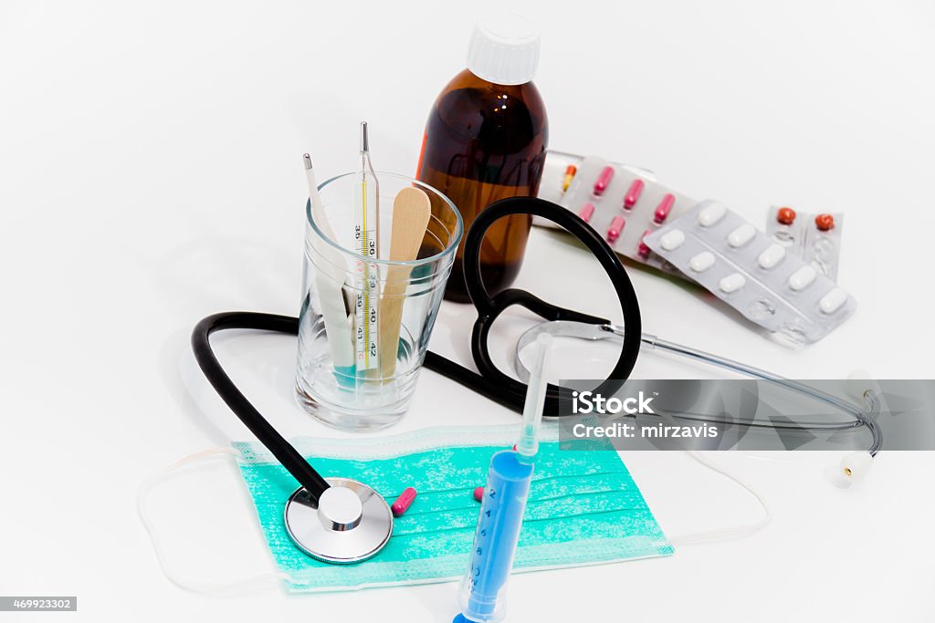 Set for flu treatment - health and medicine concept Photo of the Set for flu treatment -  pills, thermometer, nasal sprays, protective surgical mask, stethoscope, syringe... 2015 Stock Photo