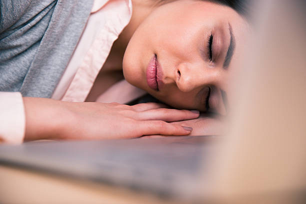 istock Beautiful woman sleeping on the table 469924248