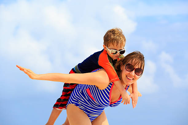 istock mother and son flying on the beach 469924284