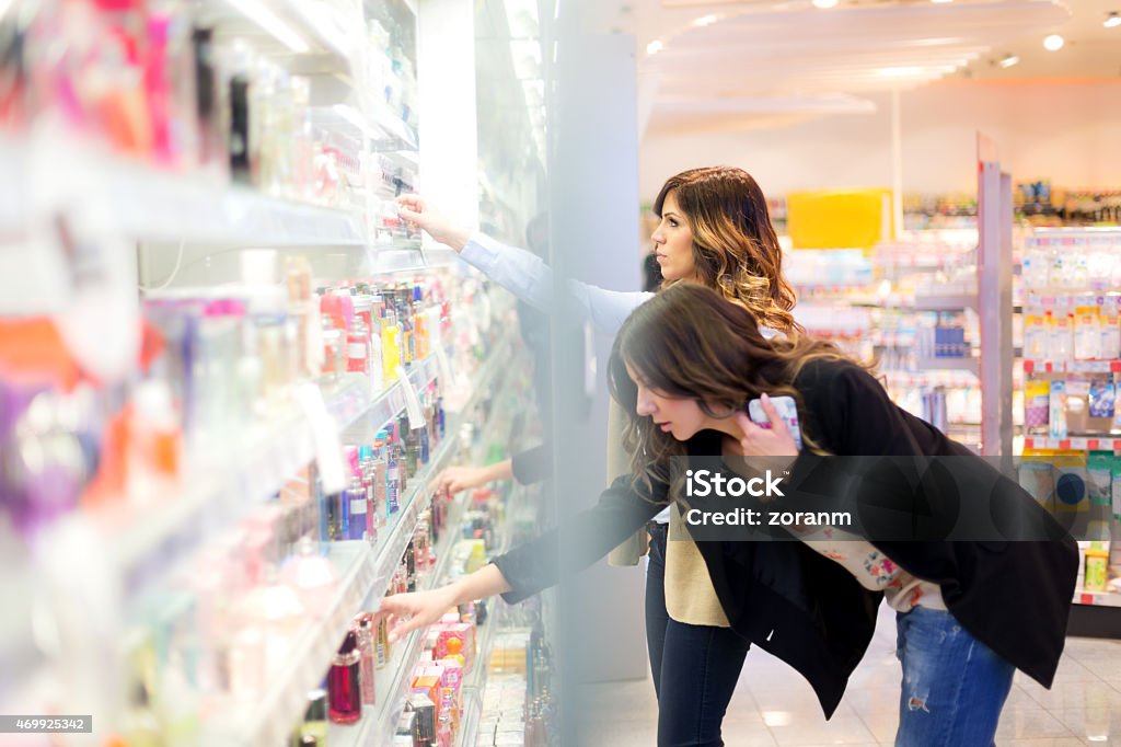 Searching for perfect scent Two young women choosing parfume in a beauty shop, copy space Store Stock Photo