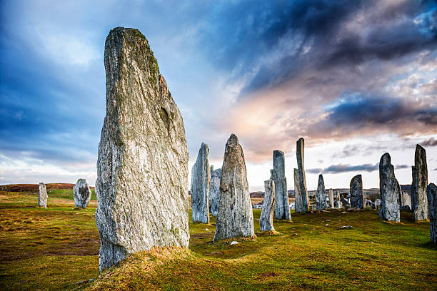 Callanish Standing Stones The ancient standing stones of Callanish (or Calanais) on Lewis in the Outer Hebrides of Scotland. Built about 5000 years ago, the deeply textured stones of Callanish are arranged in allignments of avenues and a central circle not unlike a celtic cross. megalith stock pictures, royalty-free photos & images