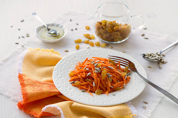 Carrot salad with raisins, sunflower seeds and honey
