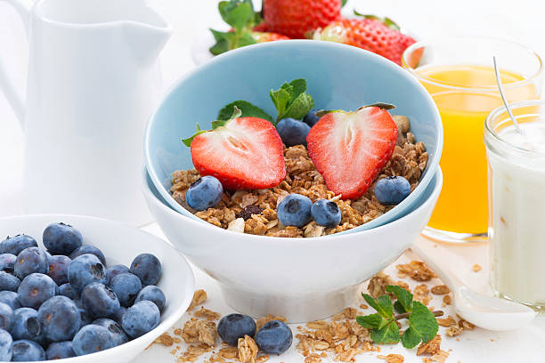 istock healthy breakfast - granola, fresh berries and milk 469927154