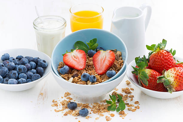 istock healthy breakfast - granola, fresh berries and milk, close-up 469927156