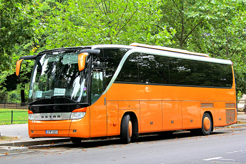 Paris, France - August 8, 2014: Orange touristic coach Setra S415HD parked at the city street.