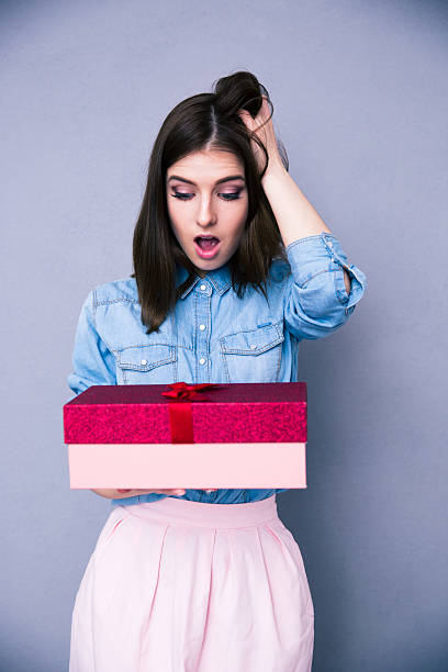 istock Surprised woman holding gift 469927976