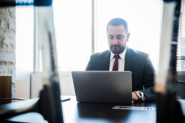 istock Middle Eastern businessman at work on laptop 469930578