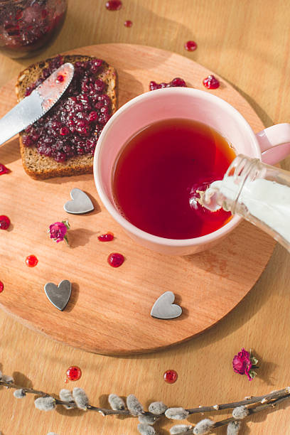 istock tea with pouring milk homemade healthy bread with blackcurrant jam 469931528