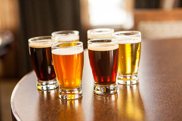 istock Six small glasses of beer samples on a bar. 469932344