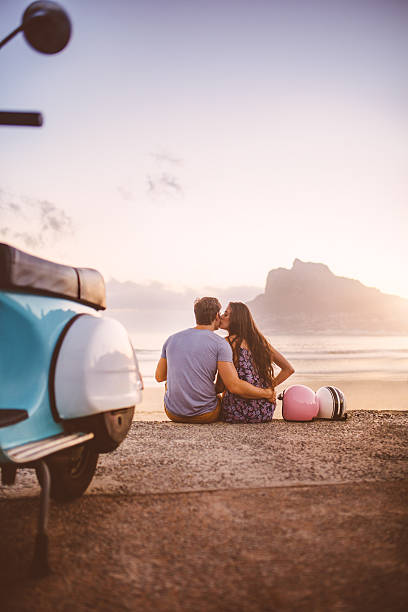 istock Couple at the beach with scooter on a road trip 469932354