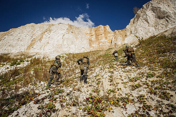 istock Soldiers team up the hill with a guide 469932526