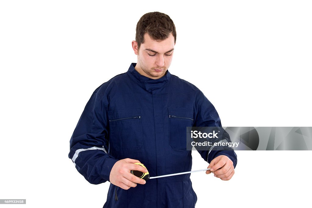 Man Using a Tape Measure Man using a tape measure Coveralls Stock Photo