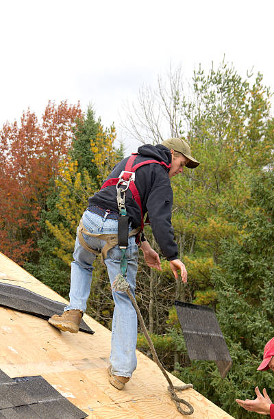 istock Roofers Installing Asphalt Shingles Wearing Safety Harness 469935099