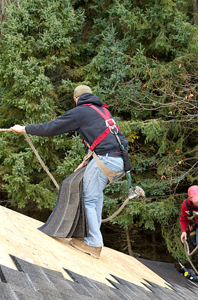 istock Roofers Holding Onto Safety Rope During House Construction 469935927