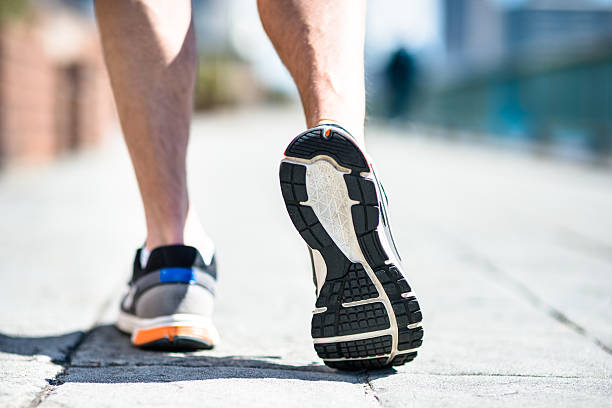 istock man doing sport and running on the city 469937018
