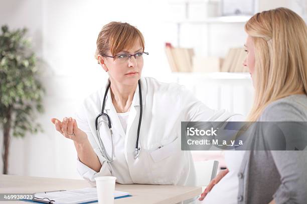 Pregnant Woman At Doctors Office Stock Photo - Download Image Now - 20-29 Years, 50-59 Years, Adult