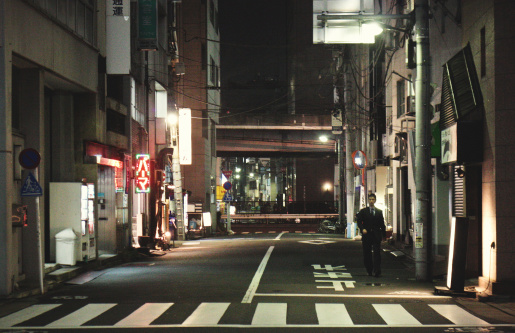 Tokyo, Japan - October 20, 2010: Man walking on the streets of Tokyo, late at night, near Roppongi station.