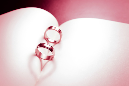 Wedding Ring on the book with love heart shadow