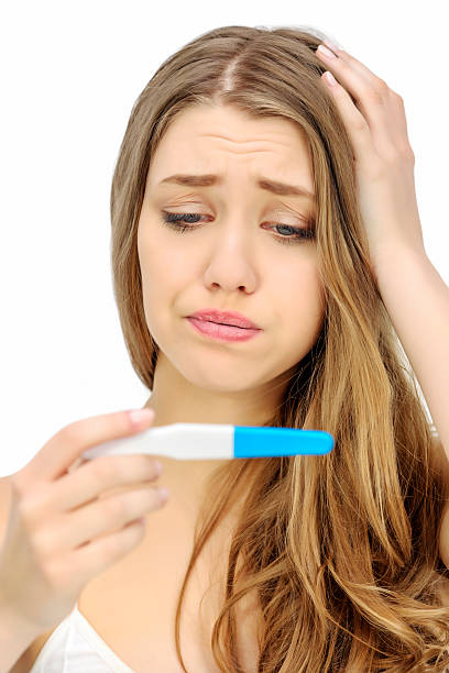 istock sad woman holding pregnancy test 469941509