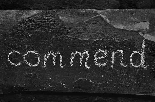 istock The word COMMEND written with chalk on black stone. 469941664