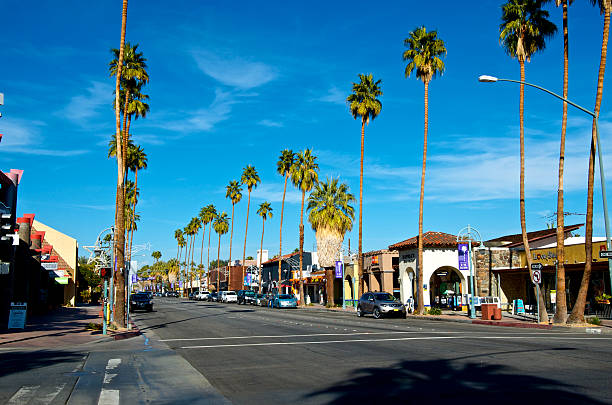 Business district street scene, Palm Springs California, USA Palm Springs, California, USA - January 10, 2014:  The main business street, Palm Canyon Drive in Palm Springs, Coachella Valley. city street street corner tree stock pictures, royalty-free photos & images