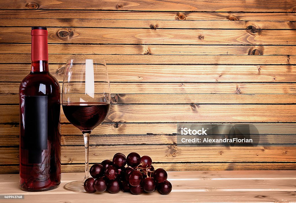 Wine on wood background Wine bottle with glass and grape on wood 2015 Stock Photo