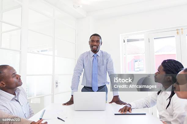 African Businessman Talking To His Colleagues Stock Photo - Download Image Now - 20-29 Years, 30-39 Years, Adult