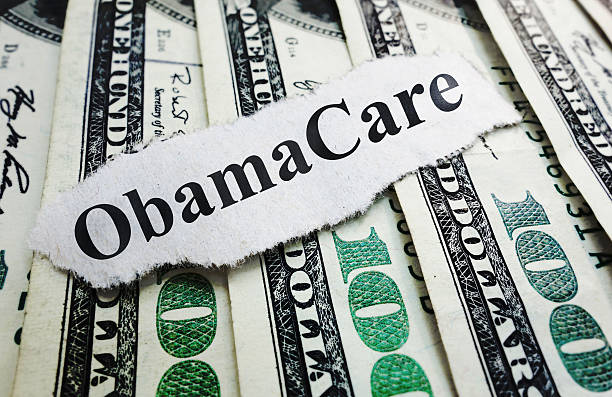 istock Money and Obama Care 469945995
