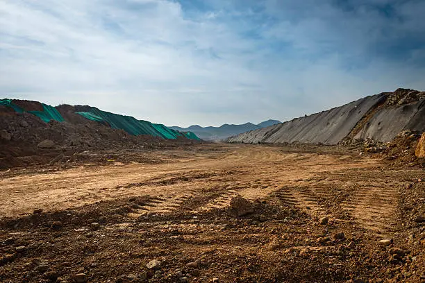 Photo of Landscape of open dirt field with off road tire tracks