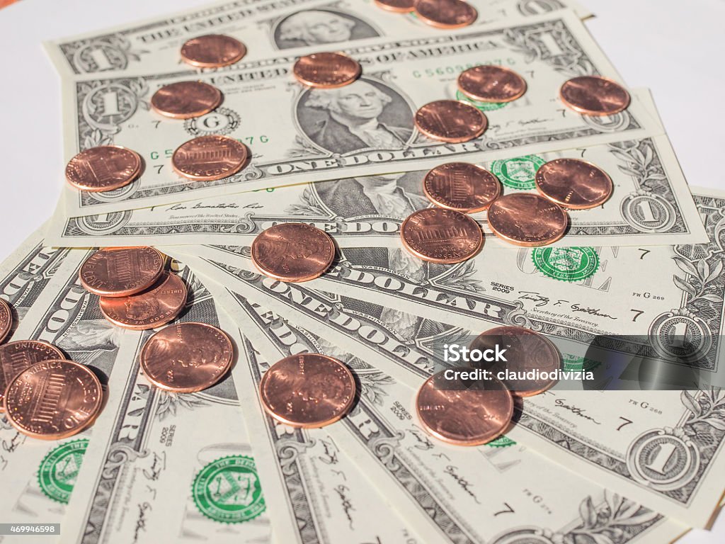 Dollar coins and notes One cent coins and One Dollar banknotes  currency of the United States useful as a background 2015 Stock Photo