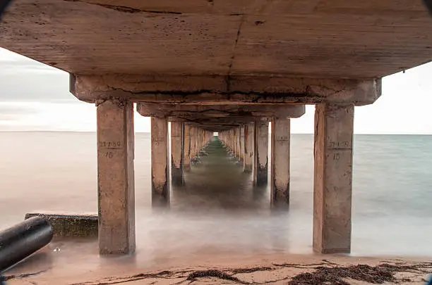 31 August 2013, a 15 second long exposure shot taken underneath Dromana Pier, on the Mornington Peninsula in Victoria, Australia.  There's plenty of room for cropping, particularly the pipe on the left -  I decided to not crop it out to give you the option.
