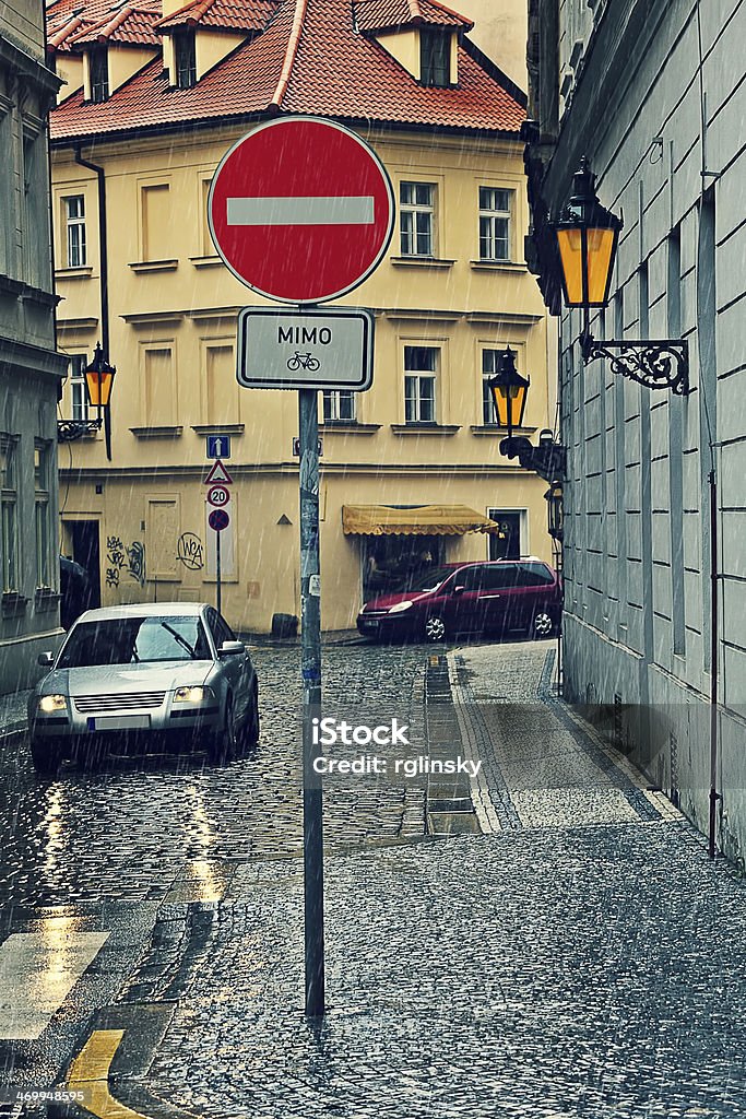 Rainy day in Prague. Narrow cobbled street on rainy day in Prague, Czech Republic (vertical composition). Autumn Stock Photo