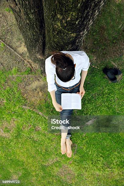 Young Woman Reading A Book In The Park Stock Photo - Download Image Now - Adult, Backgrounds, Book