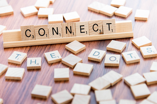 Houston, TX, USA  - April 4, 2015: Scrabble Word Game wood tiles spelling CONNECT THE DOTS