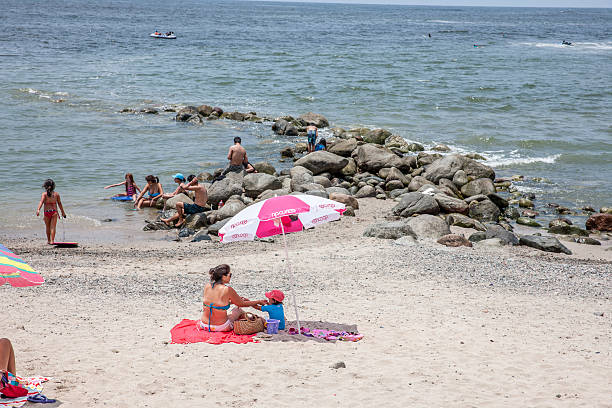 Punta Negra, Peru - January 12, 2015: Coastline and bay at Punta Negra near Lima, Peru. Families sunbathing on the beach and on the rocks