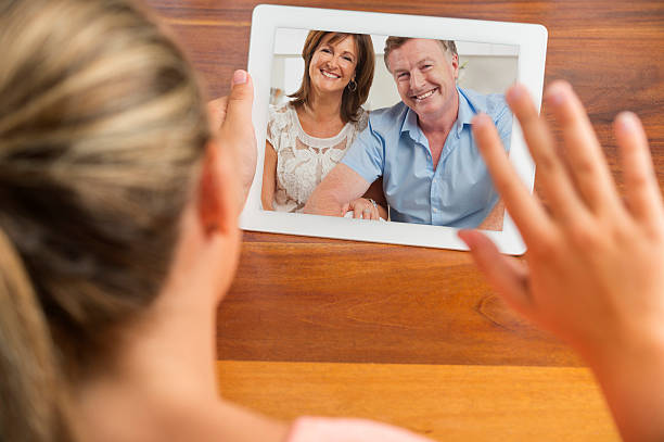 istock Young woman video calling her family 469955781