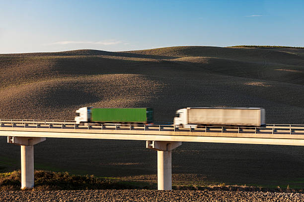 istock Two Trucks Driving on Freeway Bridge in Tuscany, Italy 469956769