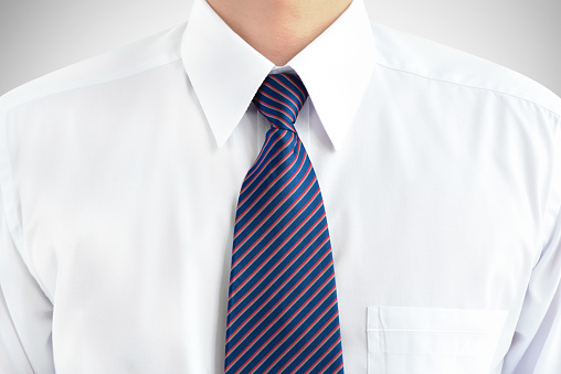 Man wearing white shirt and striped tie