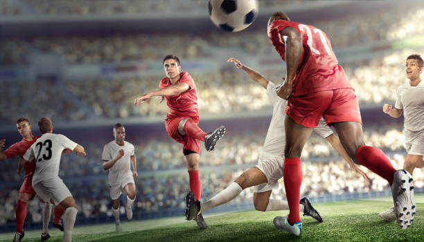 Soccer player kicking ball in stadium