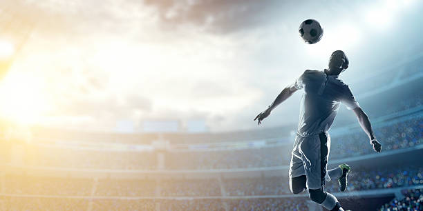 サッカー選手ボールを蹴るス��タジアム - soccer player men flying kicking ストックフォトと画像