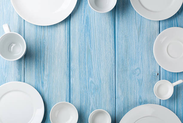 istock Empty plates and bowls on blue wooden background 469961502