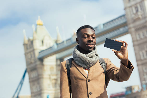 istock Young African American man taking selfie with London bridge 469962624