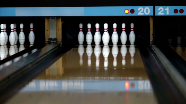 Bowler playing bowling and make a strike