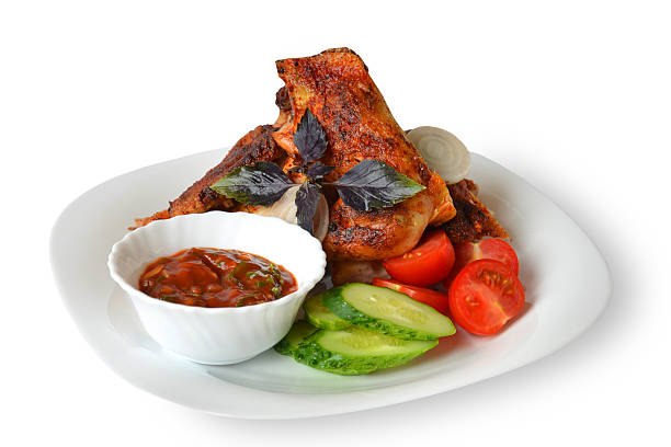 Chicken fried with vegetables and sauce on a white background