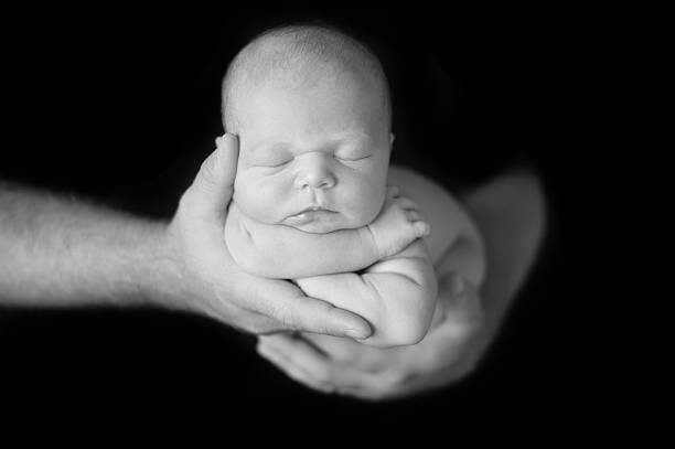 istock Father Holding Newborn Girl 469963165