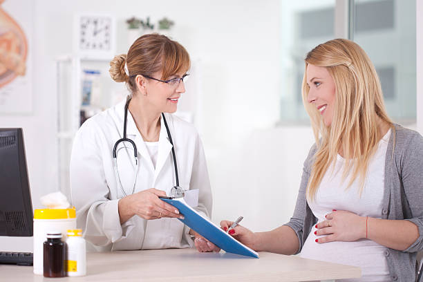 istock Pregnant woman at doctor's office. 469963739