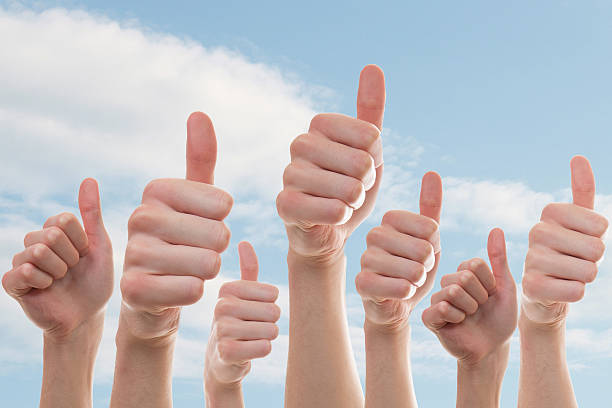Collection of people showing thumbs up stock photo