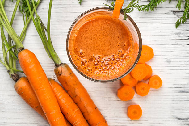 istock Glass of fresh carrot juice, top view 469964334